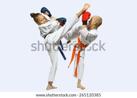 Girl doing a high kick over boy\'s head