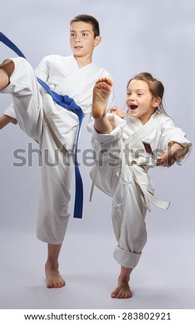 Brother and sister are training hitting  mae-geri