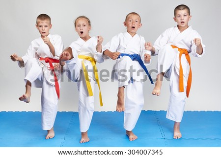 In karategi four athletes beat kick mae-geri