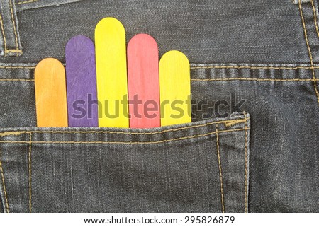 Colorful wood ice lolly sticks, Ice cream sticks, in bag jean background
