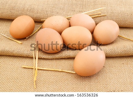 Fresh eggs from farm in burlap burlap background