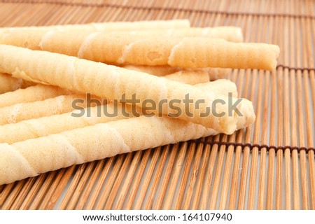 Wafer roll sticks cream rolls on bamboo mat