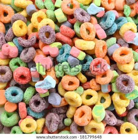 Delicious and nutritious fruit cereal loops flavorful on background, healthy and funny addition to kids breakfast