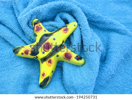 blue towels and starfish for wellness on background