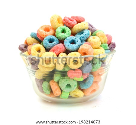 Delicious and nutritious fruit cereal loops flavorful in glass bowl in white, healthy and funny addition to kids breakfast