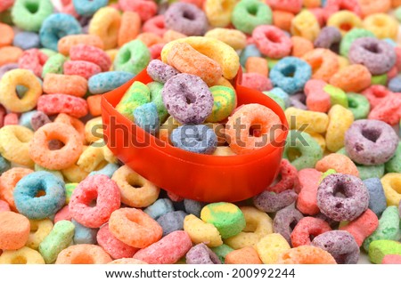 Delicious and nutritious fruit cereal loops flavorful in bowl on white background, healthy and funny addition to kids breakfast