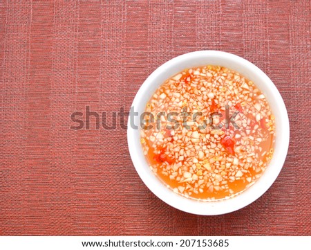 A fish sauce bowl vietnamese on red background