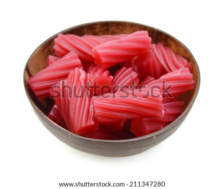 Bright Red Licorice Candy shaped like a twisted rope on wooden bowl