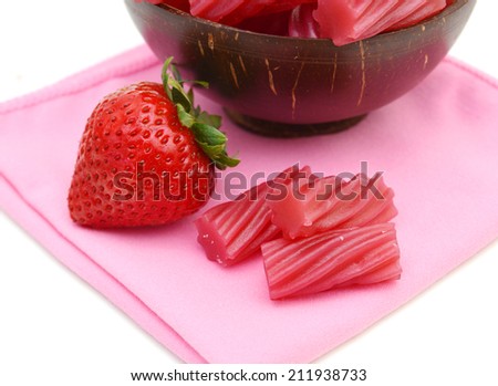 Bright Red Licorice Candy shaped like a twisted rope on wooden bowl