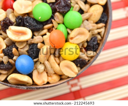 trail mix in wooden bowl on bamboo mat