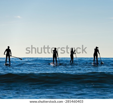 Stand up paddle boarding in Pacific surf
