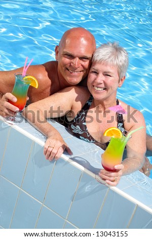 happy couple relaxing by the pool enjoying holidays