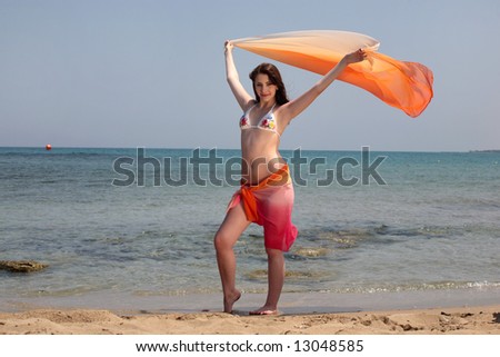 stock photo : beautiful teen girl in swimwear holding up a wrap standing on ... stock photo beautiful teen girl in swimwear holding up a wrap standing on the beach 13048585 stock photo : beautiful teen girl in swimwear holding up a wrap standing on ...