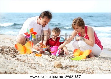young happy family on the beach