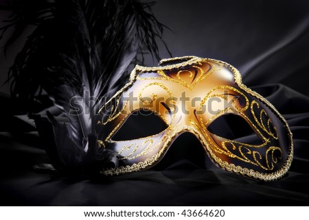 Carnival mask on black silk background