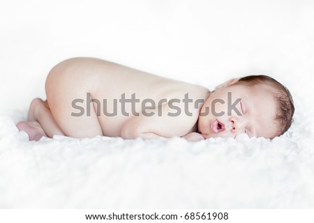 Soft-focused portrait of a newborn baby sleeping. Shallow DoF.