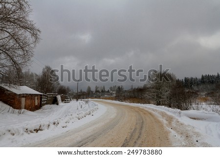 Turn on the dirty road in the winter in the settlement