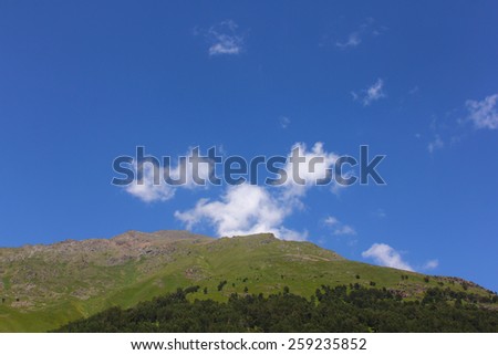 The hill in bright clear fine day with the blue sky and clouds. summer landscape. mountain landscape. bright sunny clear day