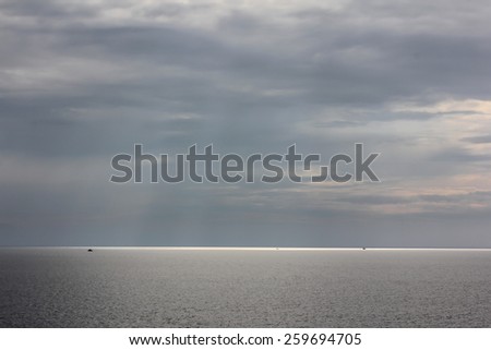 View of water in the Gulf of Thailand in bright sunny and cloudy day with beams from the sun.