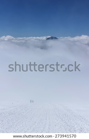 Above the sky. People in a cloud in the mountains of the Caucasus.