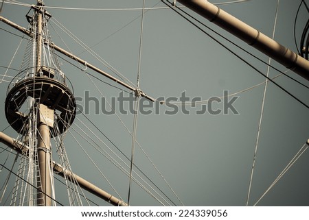 grey background with sailing and adventure concept, old ship masts and empty sky