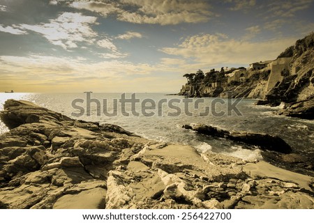 Retro panoramic seascape. Postcard from Italy, sea and rocks in Liguria.