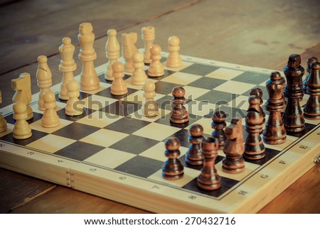 Chess game set with wooden chess pieces retro revival photography.