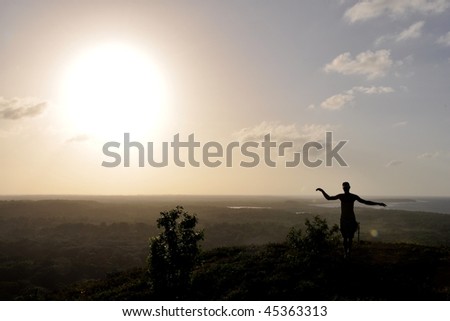 Silhouette of man standing on the top of a Caribbean island; Utila, Bay Islands, Honduras