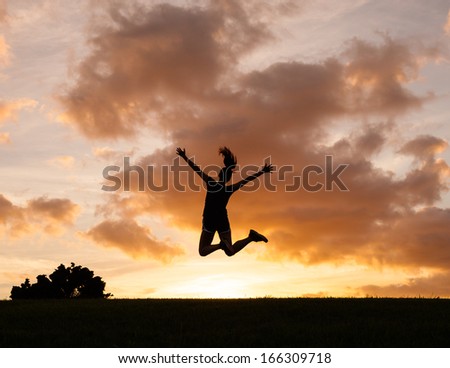Happy Woman Jumping Against Sunset. Freedom Concept. Enjoyment.