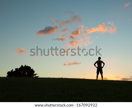 Silhouette of the person on sun glow background. Sport and active life