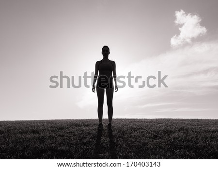 Silhouette of woman on sun glow background. Sport and active life