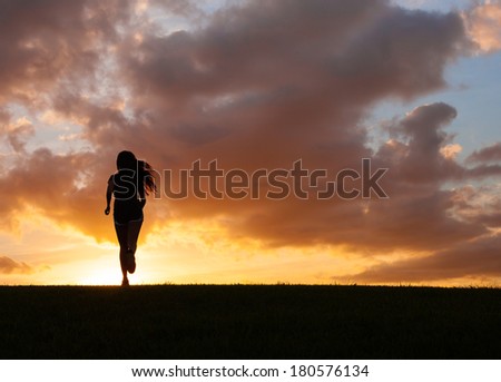 Silhouette of woman running.