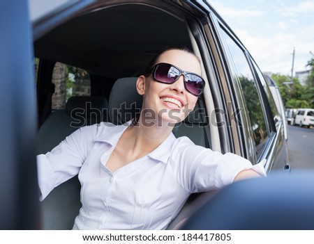 Happy young driver woman in the car.