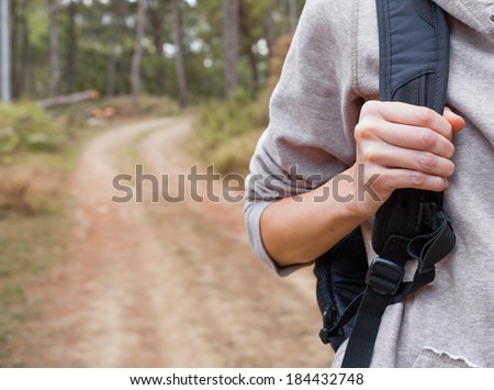 Hiker woman walking through the forest. Extreme sport concept.