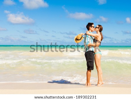 Young couple in love kissing at the beach in Hawaii, USA. Love and kiss.