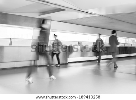 Business people commuting, abstract blurred motion.