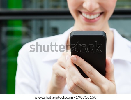 Young professional business woman using mobile smart phone.