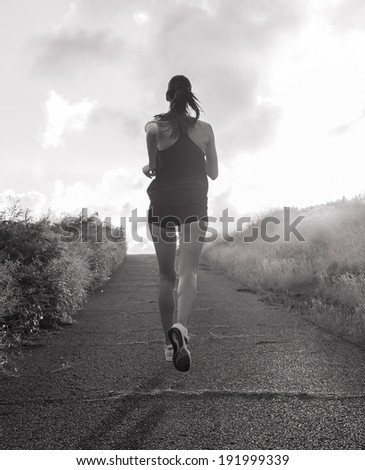 Back view silhouette of a runner woman running