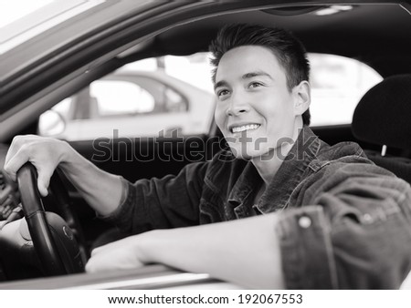Happy young driver man in the car.