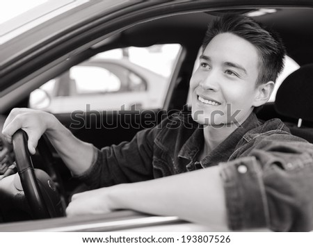 Smiling men sitting in the car.