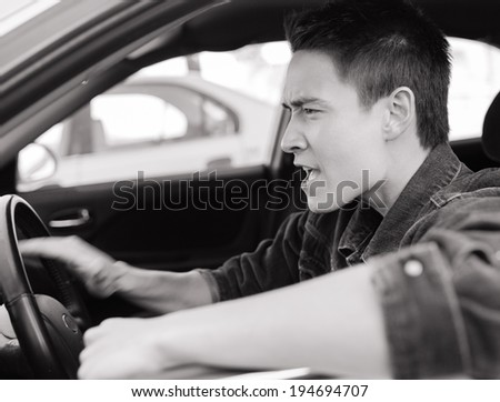 Transportation concept - Stressed male driver.