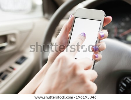 Female using mobile smart phone in the car.