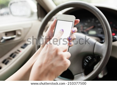 Woman using mobile phone in the car.