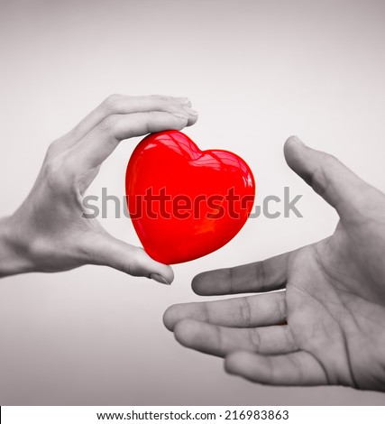 Love concept Woman giving a heart to man Love concept Woman giving a heart to man