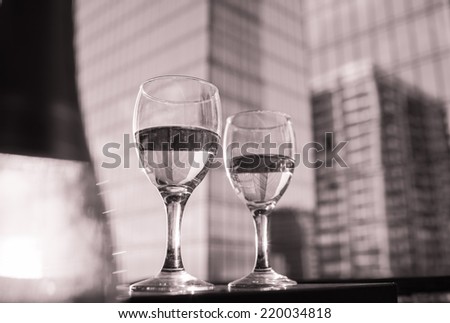 Glasses of white wine with city view. Fine dining concept.