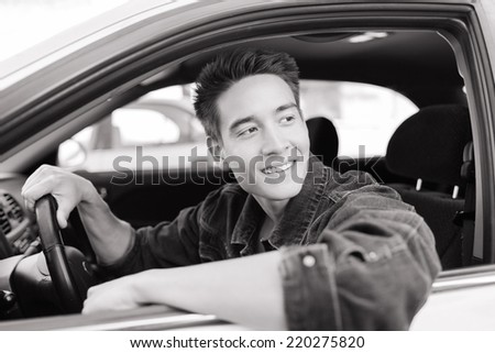 Handsome young man sitting in the car