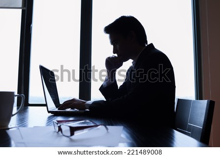 Business man using laptop computer at the office