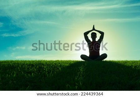 Yoga and fitness. Silhouette of man meditating