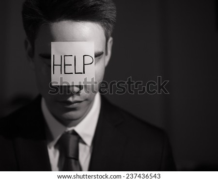 Frustrated business man with adhesive note on his forehead