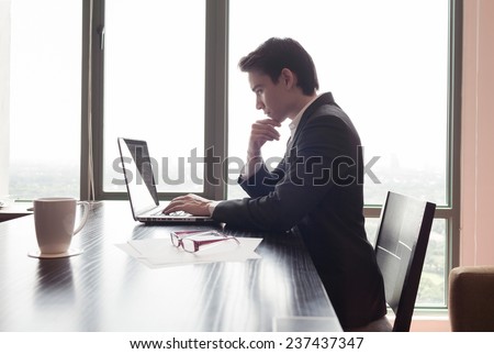 Businessman using laptop computer at the office